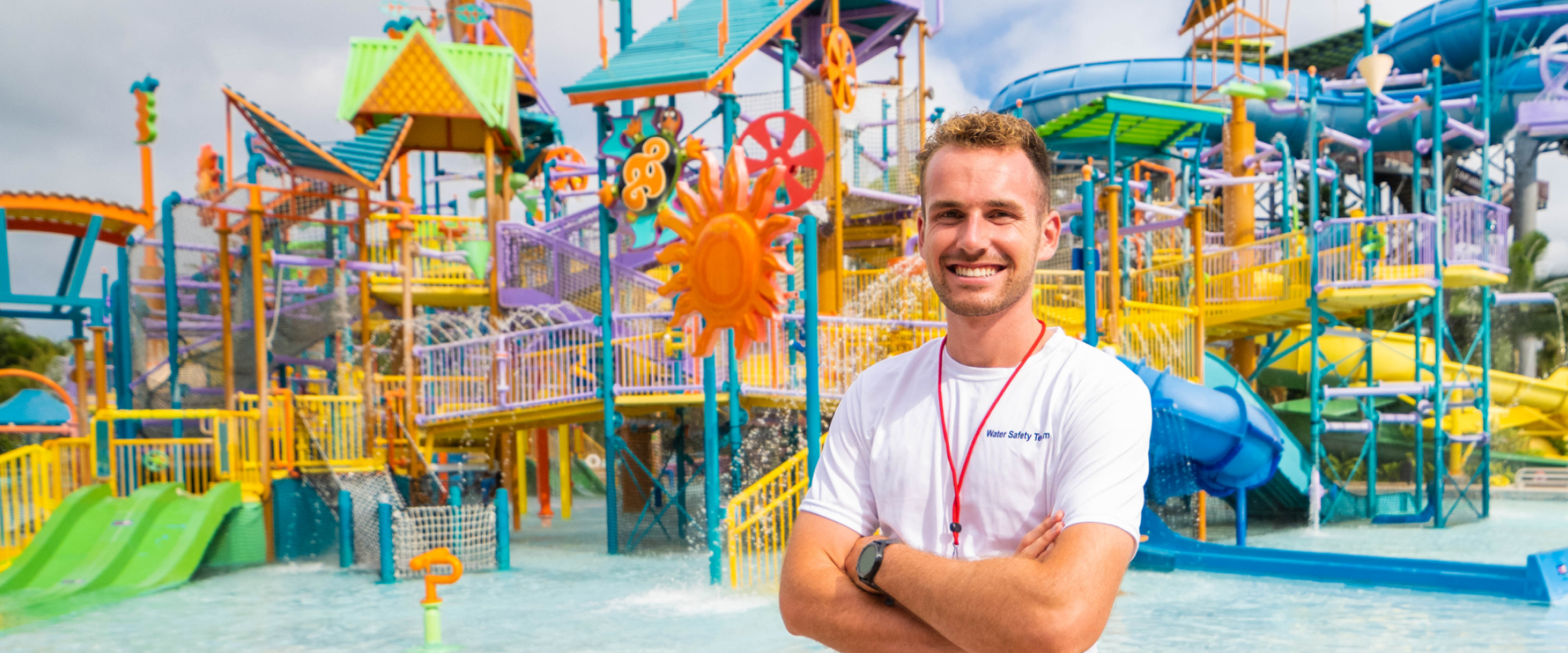 A member of the Aquatica water safety team stands in front of an aquatic playground