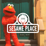 The Sesame Place logo over a picture of Elmo standing on the stairs outside