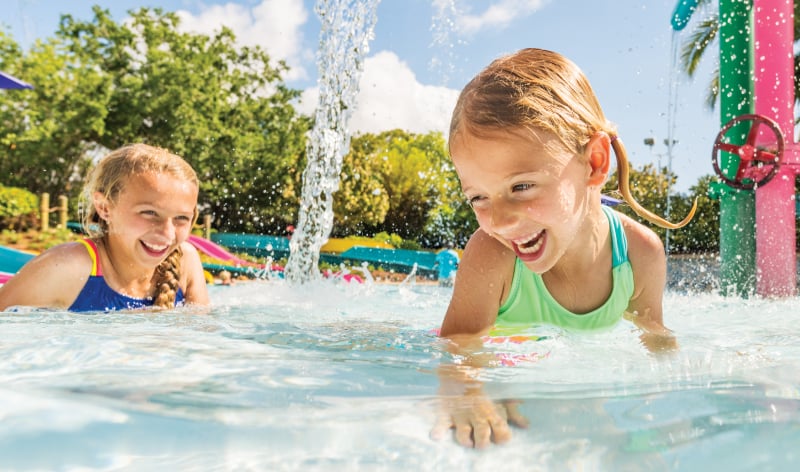 Two girls playing in a splash pool