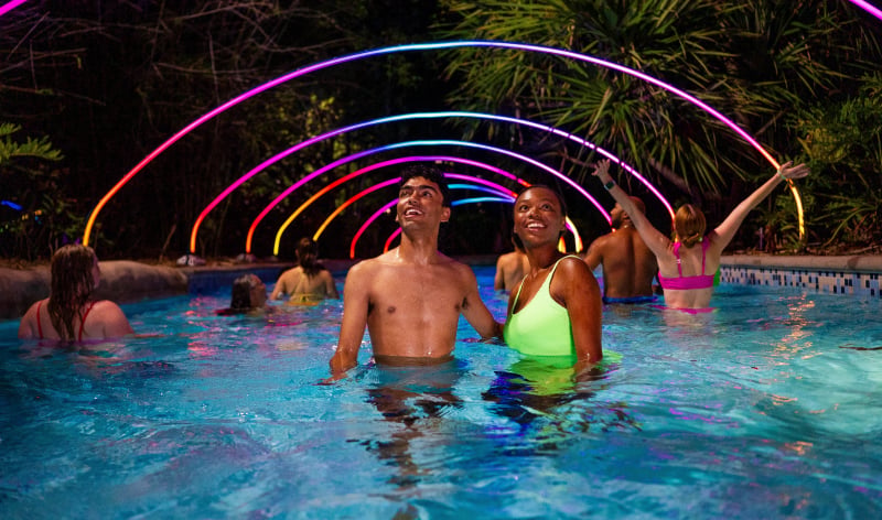 People in a lazy river at night