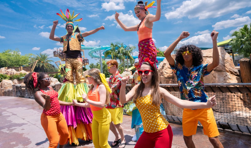 People dancing in colorful beach outfits