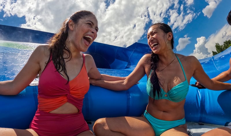 Two women on a family tube slide