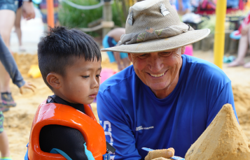 Two people building a sandcastle
