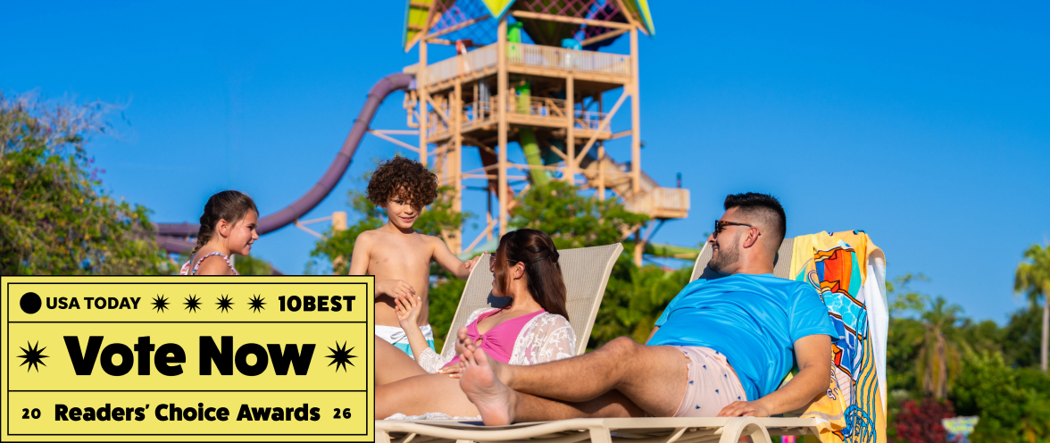 Family on beach chairs in front of a waterslide