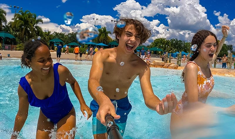 Teens splashing in the wave pool at Aquatica Orlando