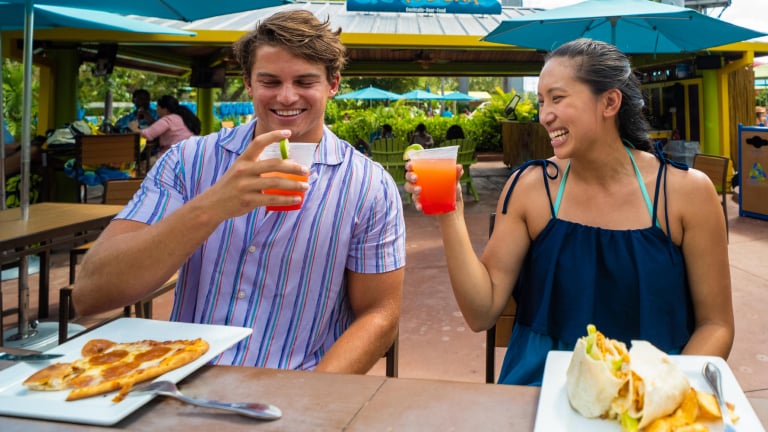 Couple eating and having drinks at Aquatica San Antonio.